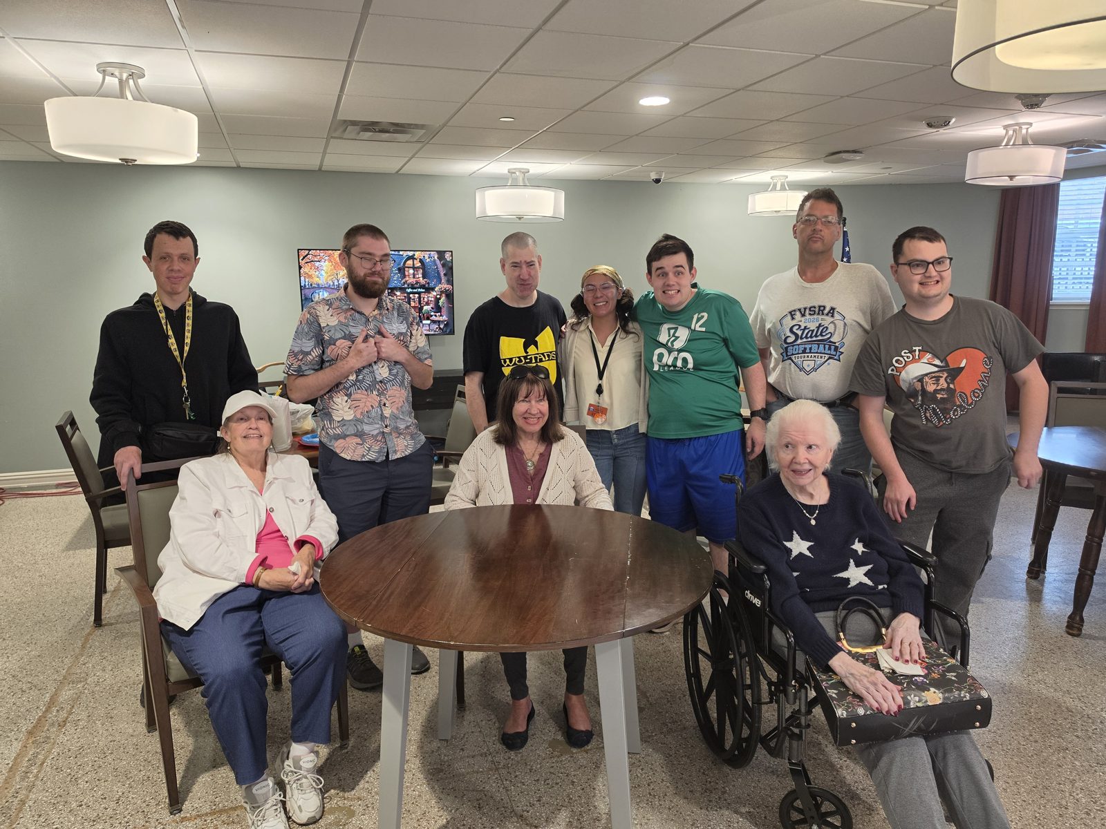 CAI participants and senior neighbors gather around a table at Bardwell Residences.